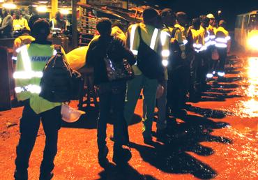 Workers getting ready for work in a country where the government has mortgaged their rights for the perks received from extractive companies.