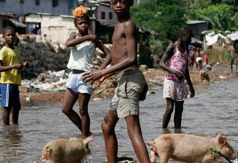While children and pigs roam the sources of drinking water in Freetown, US APC party activists deny there's any cholera afflictions or deaths in Sierra Leone.