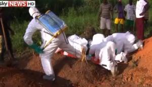 Sky TV picture of the burying of the dead under secured conditions.