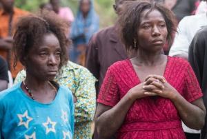 The faces say it all - grief at the loss of a loved one clutched away by the cold hands of the deadly ebola virus.