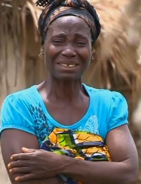 A face of grief. This woman in Liberia wails uncontrollably as a neighbour is removed for burial in a most undignified, but necessary manner. The impact of Ebola on communities.