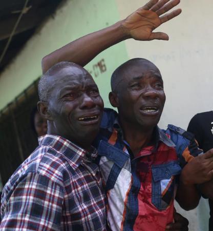 The devastating effect of the disease. Men in tears in Liberia as the Ebola Virus Disease takes its toll.