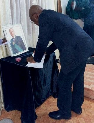 AWOKO editor Kelvin Lewis signs the book of condolence for journalist Samuel John