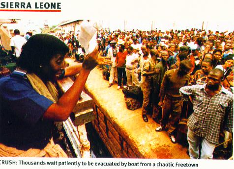 Civilians waiting by the quayside to flee the mayhem - Photo: Focus on Africa magazine