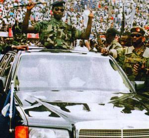 New Head of State Captain Valentine Strasser in triumphant convoy holding aloft the staff of state authority